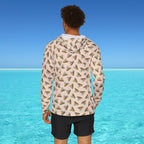 Person wearing a patterned hoodie with a blue sky and ocean background