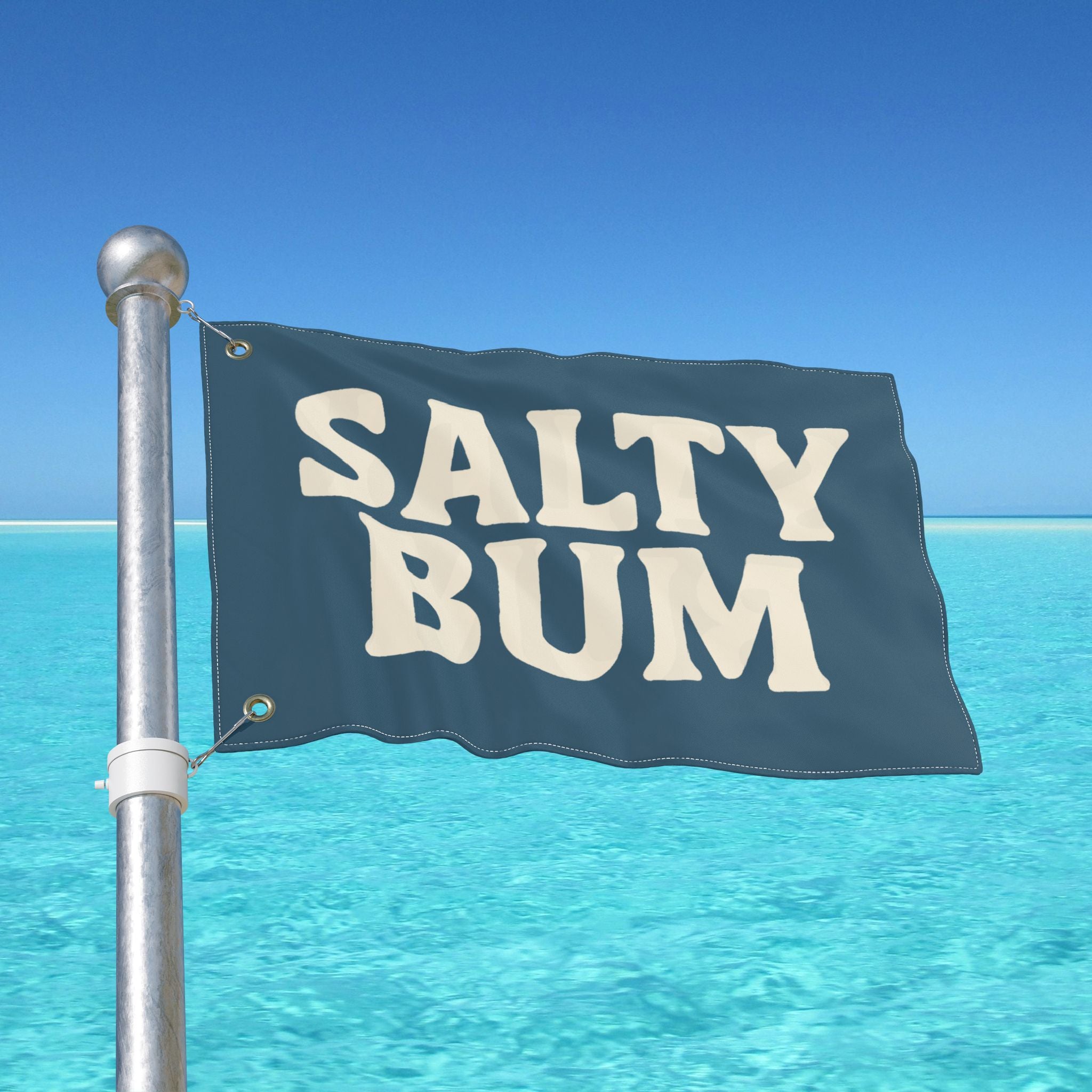 Flag with 'Salty Bum' text against a clear blue sky and ocean.