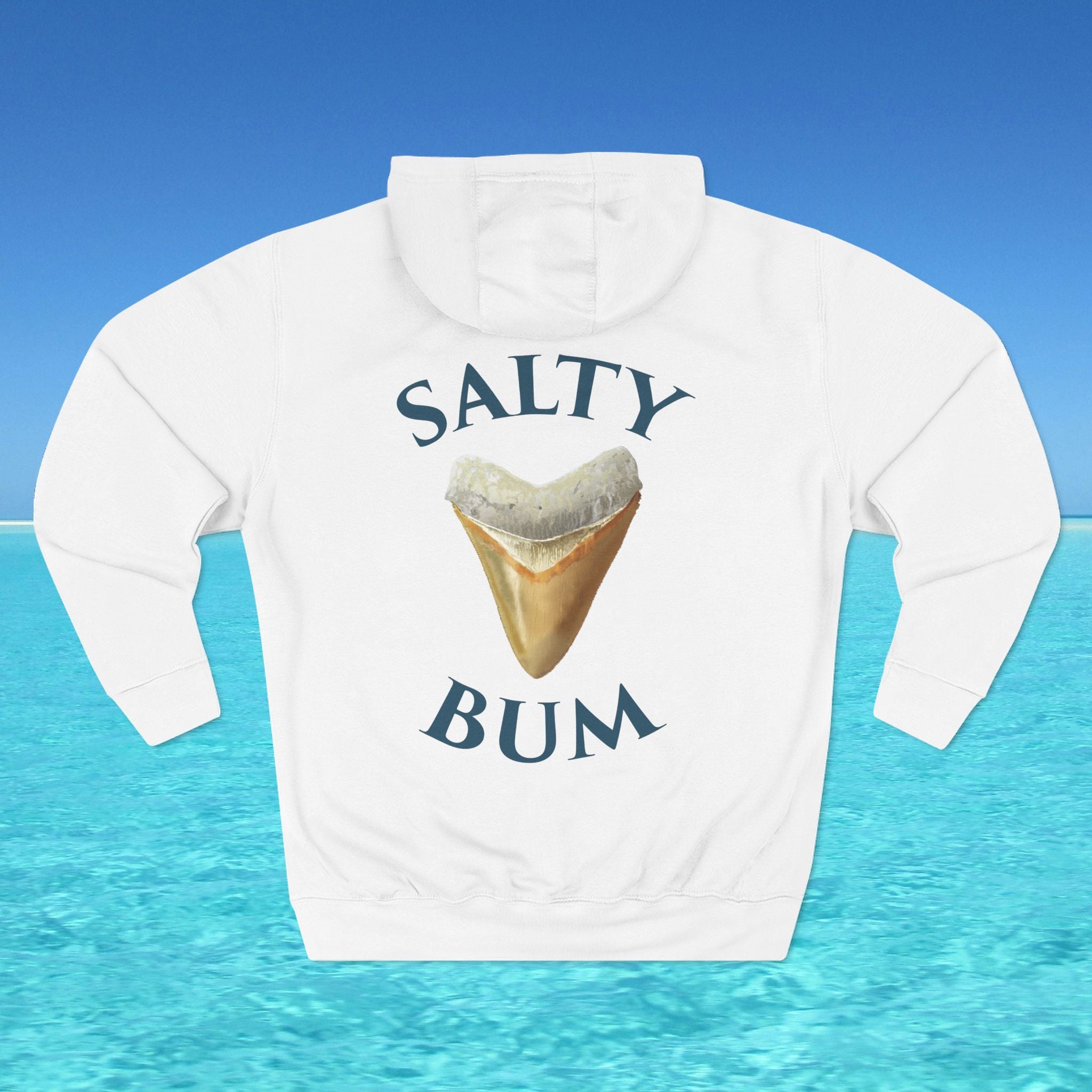 White hoodie with 'Salty Bum' text and shark tooth graphic on a blue water background