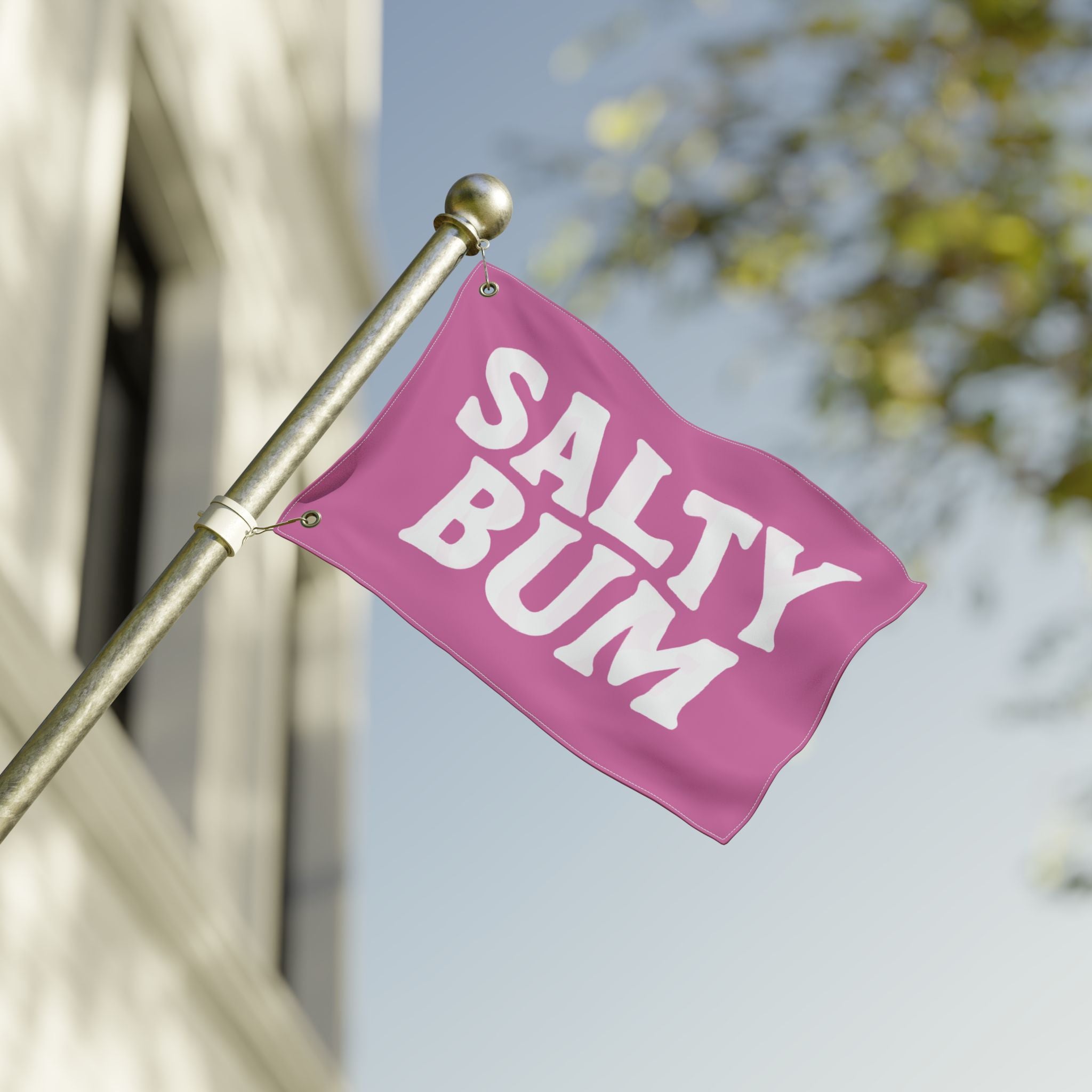 Pink flag with 'Salty Bum' text on a pole against a blurred background