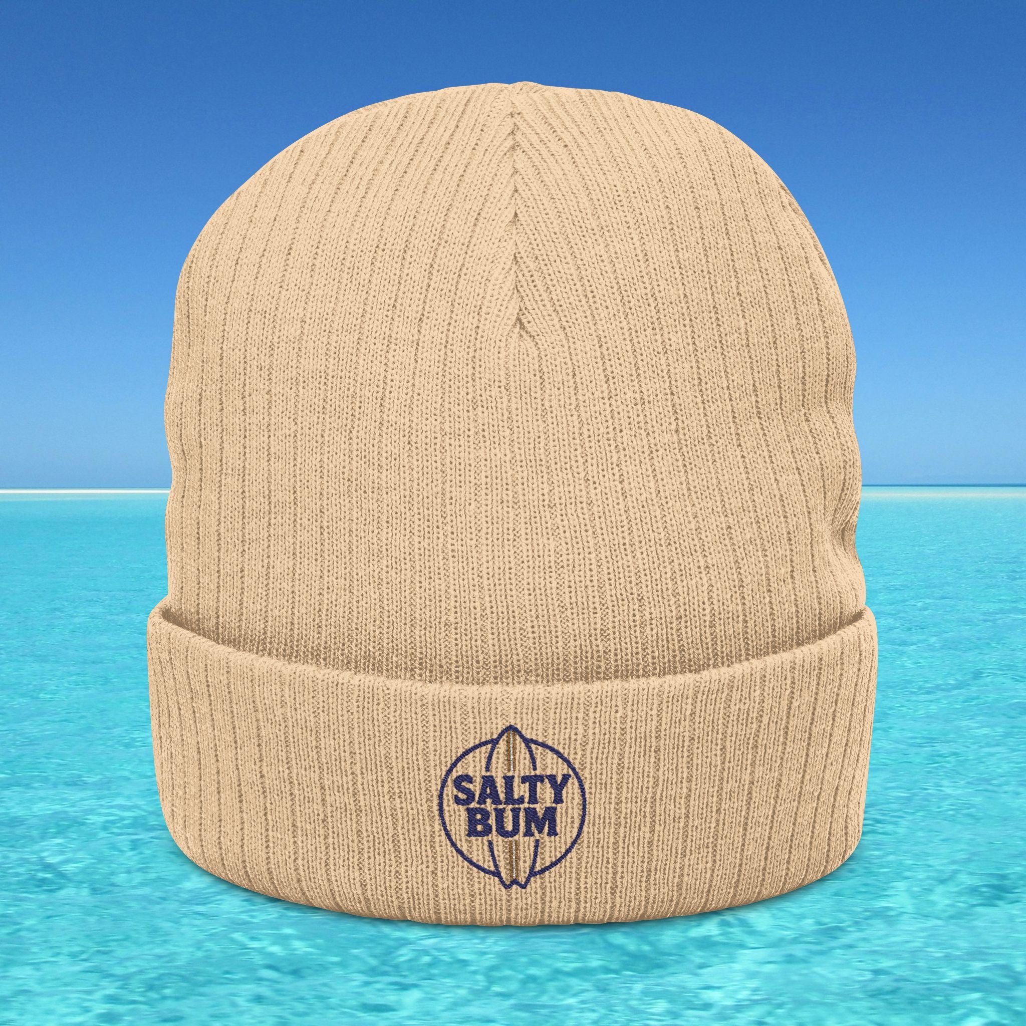 Beige beanie with 'Salty Bum' logo on a blue water background