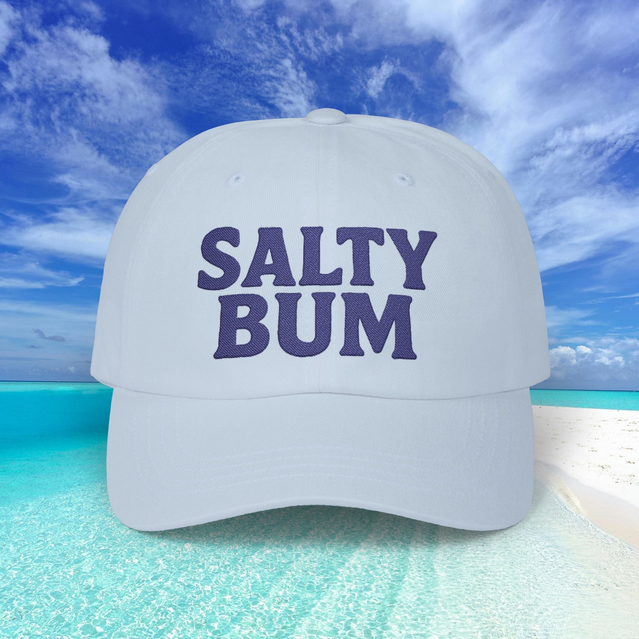 White cap with 'Salty Bum' text against a beach background