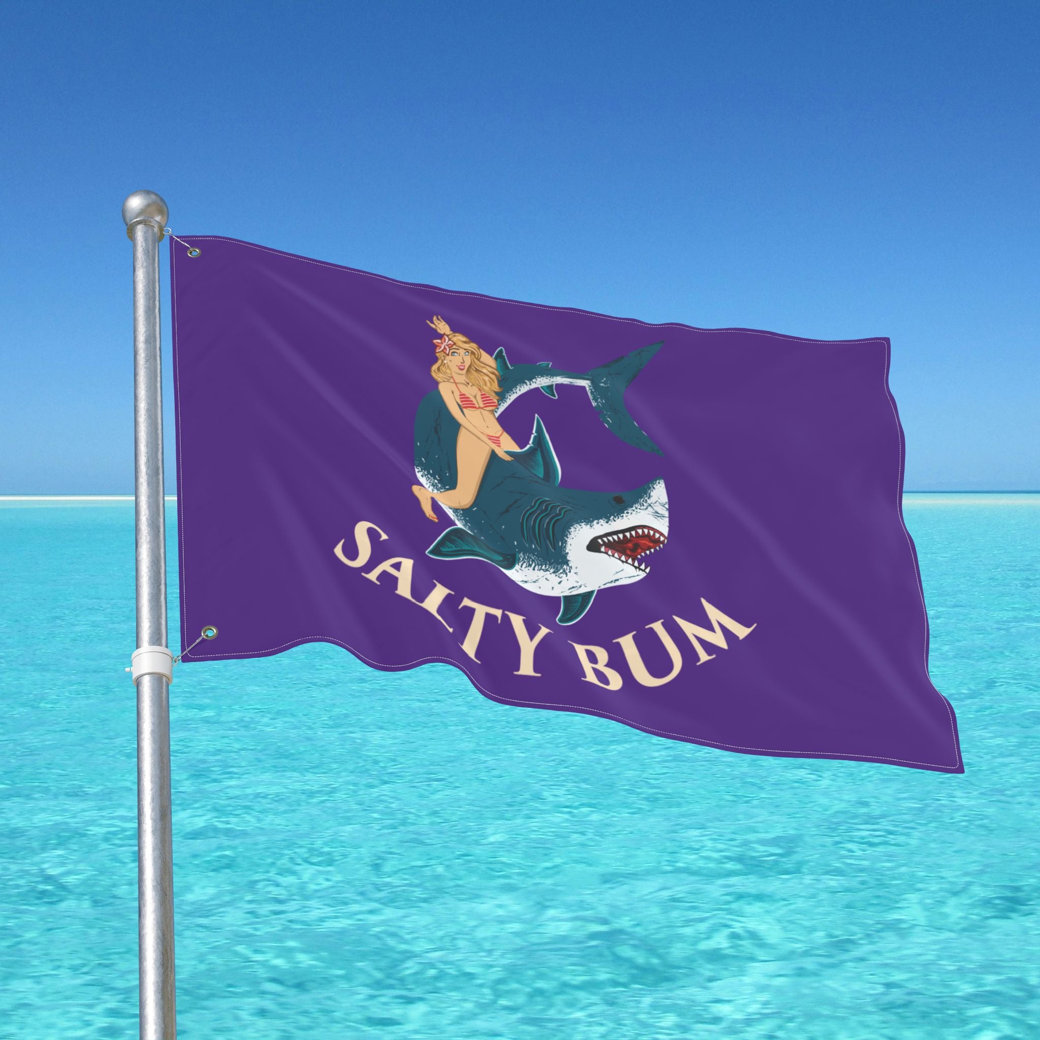 Flag with 'Salty Bum' design on a pole against a blue sky and water background