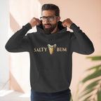 Man wearing a black hoodie with 'Salty Bum' text and graphic, standing indoors.