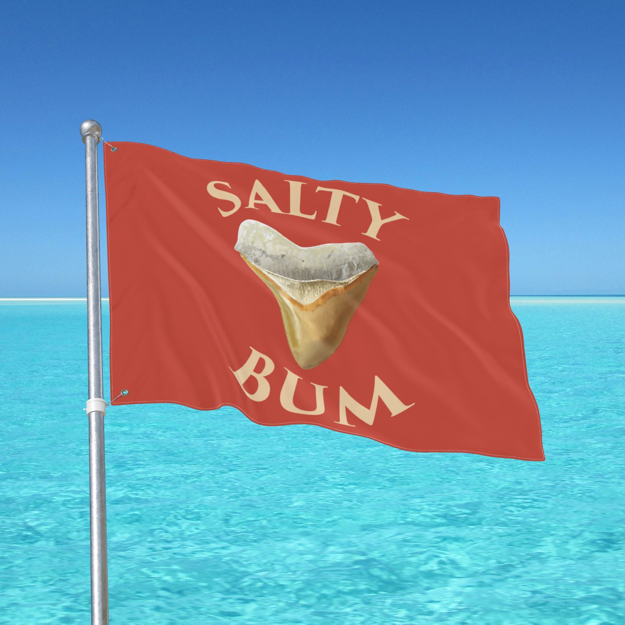 Flag with 'Salty Bum' text and a shark tooth graphic against a blue ocean and sky background