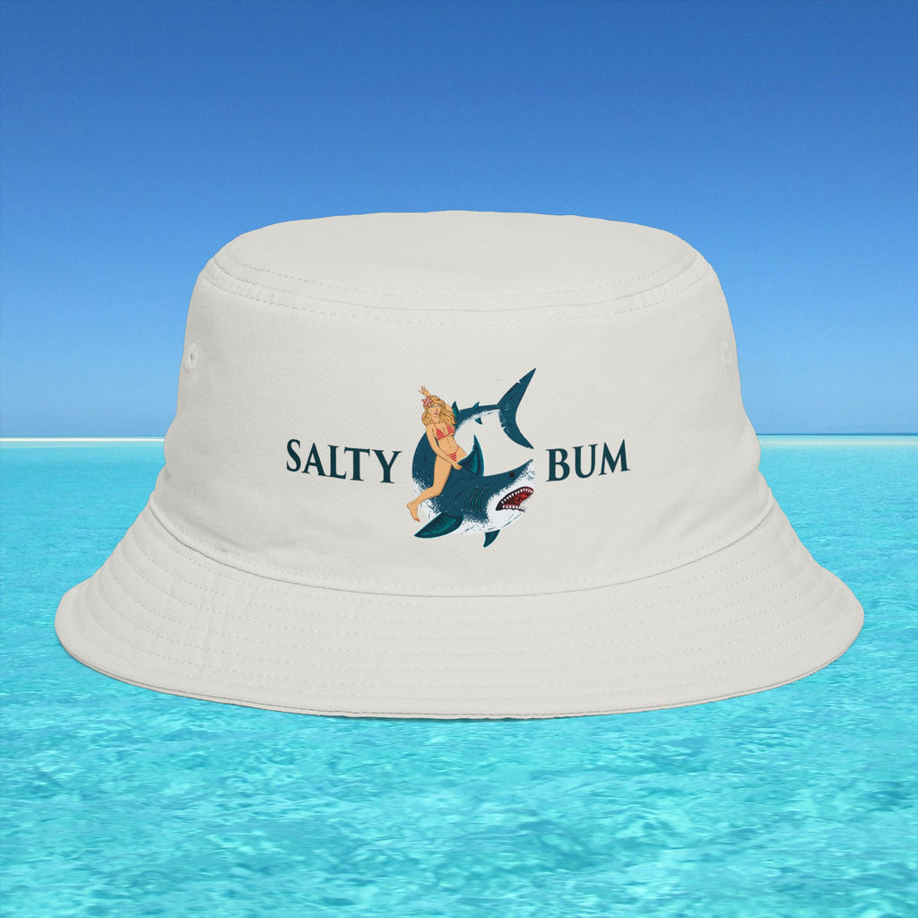 Beige bucket hat with 'Salty Bum' design on a blue water and sky background