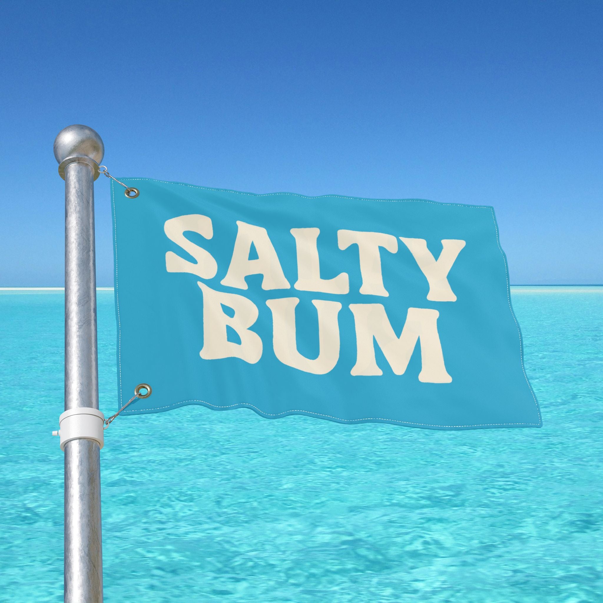 Flag with 'Salty Bum' text against a clear blue sky and ocean.
