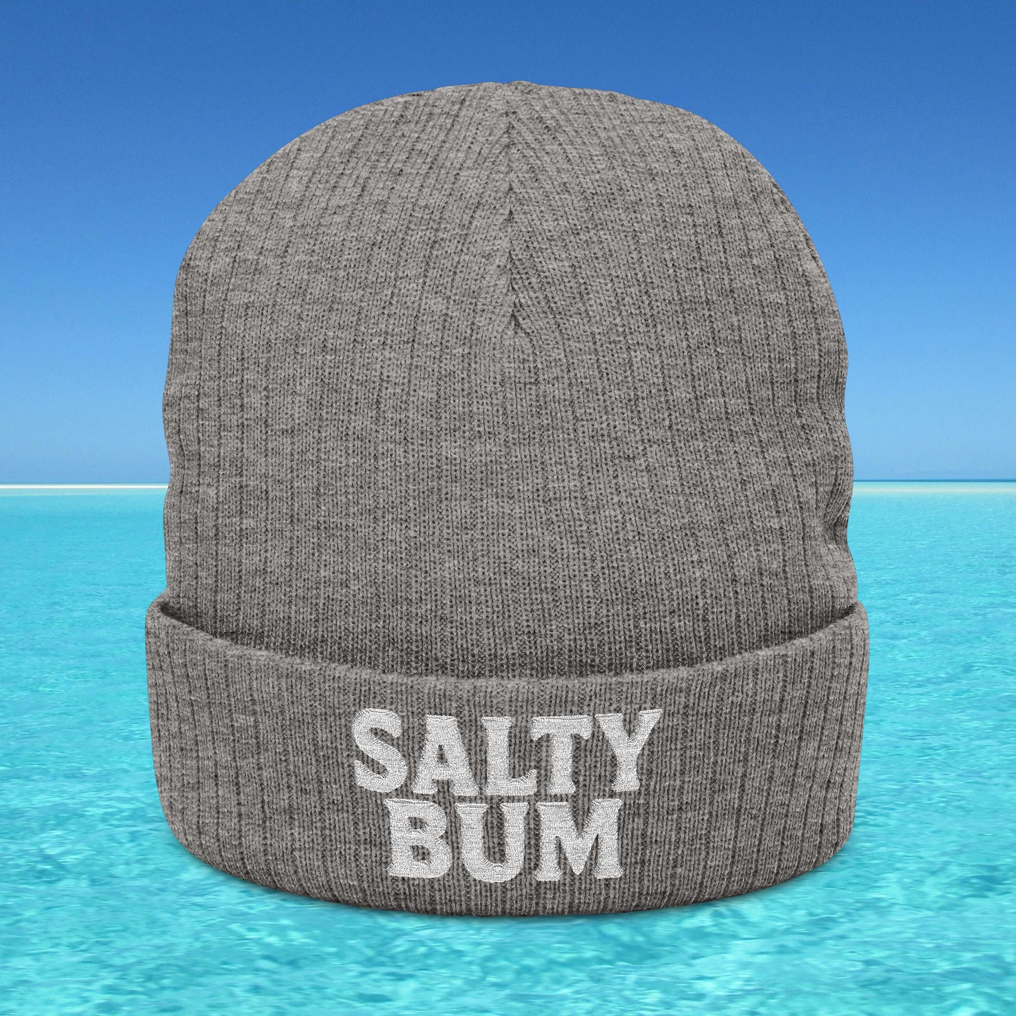 Gray beanie with 'Salty Bum' text on a blue water and sky background