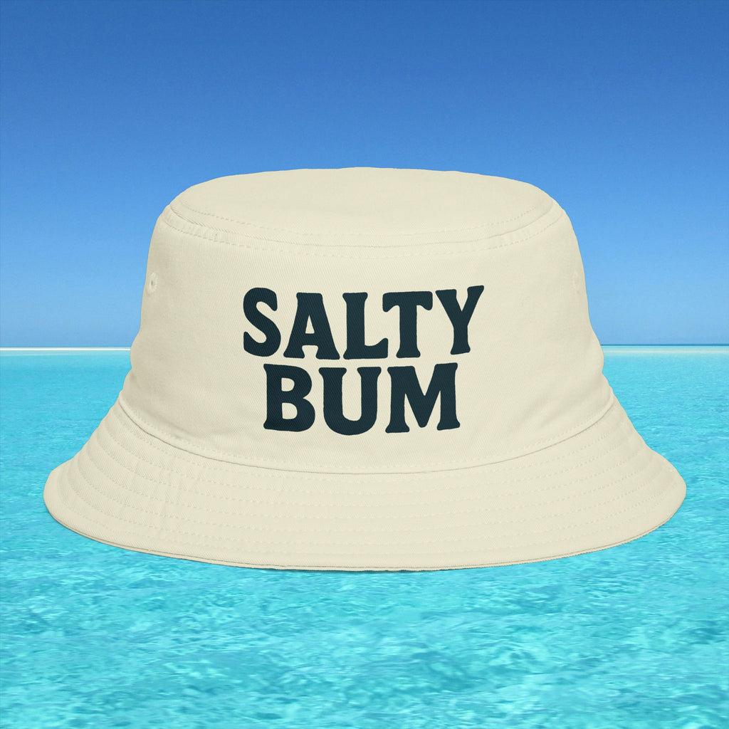 Beige bucket hat with 'Salty Bum' text floating on clear blue water with a blue sky background