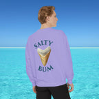 Person wearing a purple sweatshirt with 'Salty Bum' text and ice cream graphic, standing against a blue water and sky background.