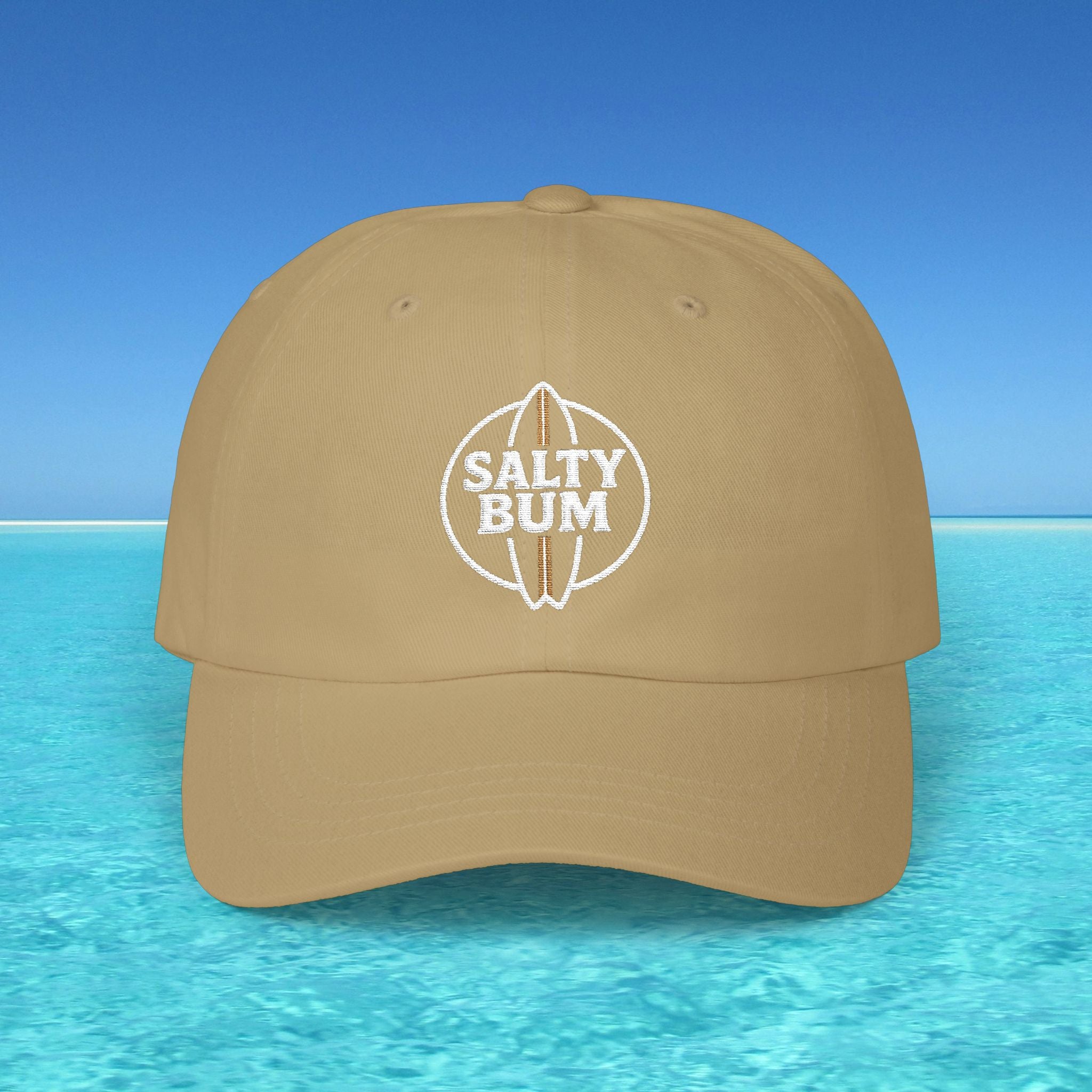 Brown cap with 'Salty Bum' logo on a blue water and sky background