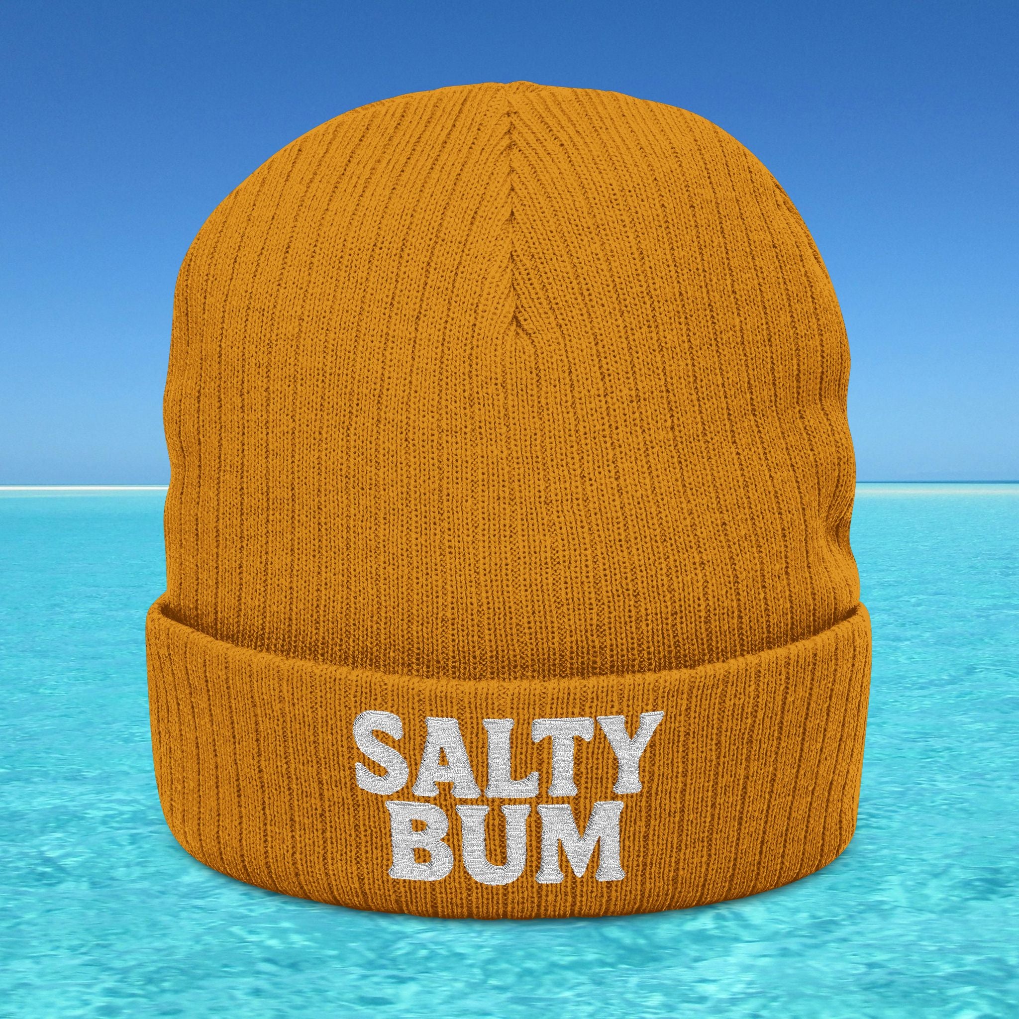 Orange beanie with 'Salty Bum' text on a blue water and sky background